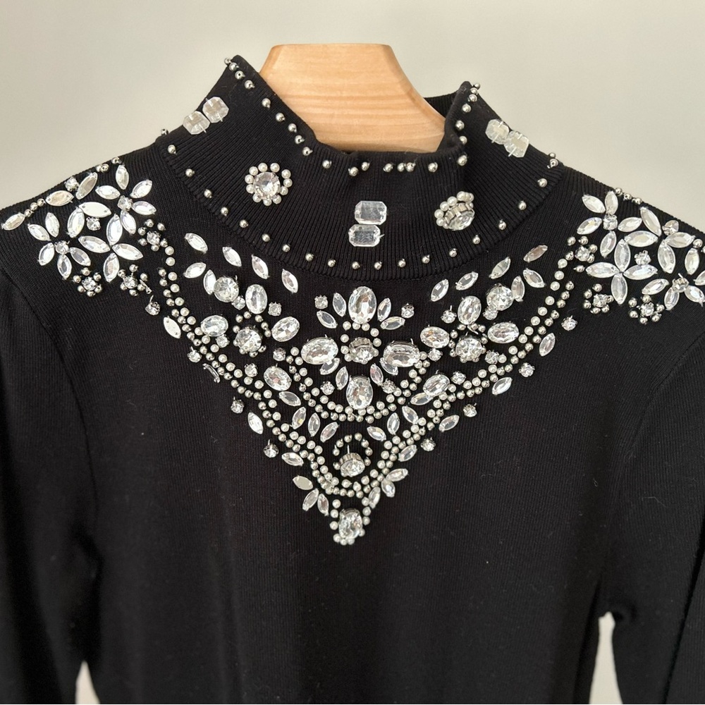 Tunic top with back zipper. Front has beaded design.